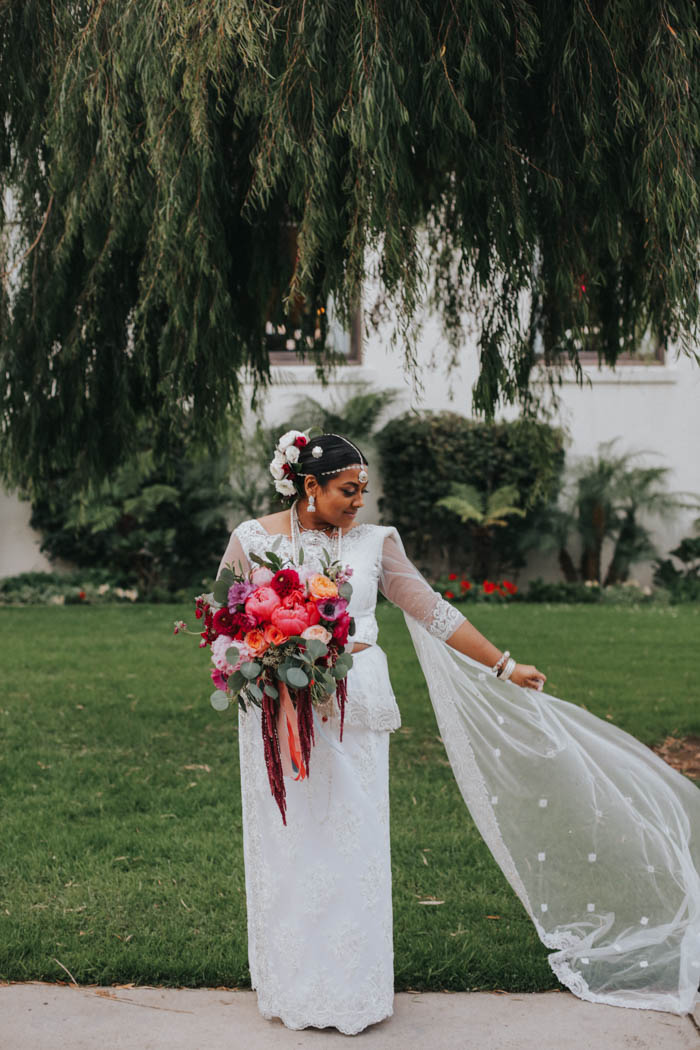 Modern Sri Lankan Bride with colorful, luxury bridal bouquet, beautiful hair flowers, and a gorgeous flowing veil.
