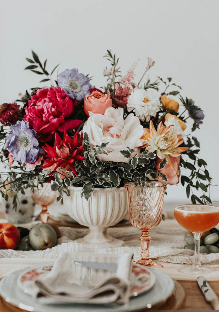 Lush and organic jewel-toned centerpiece in white ceramic compote.