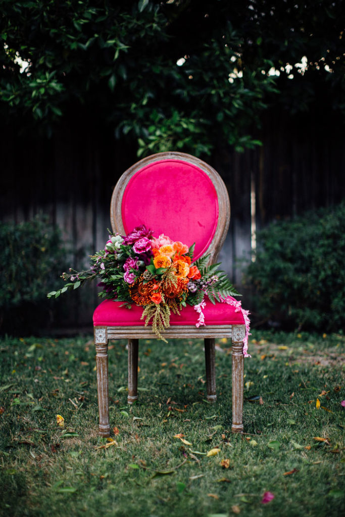 Colorful bouquet on pink vintage chair.