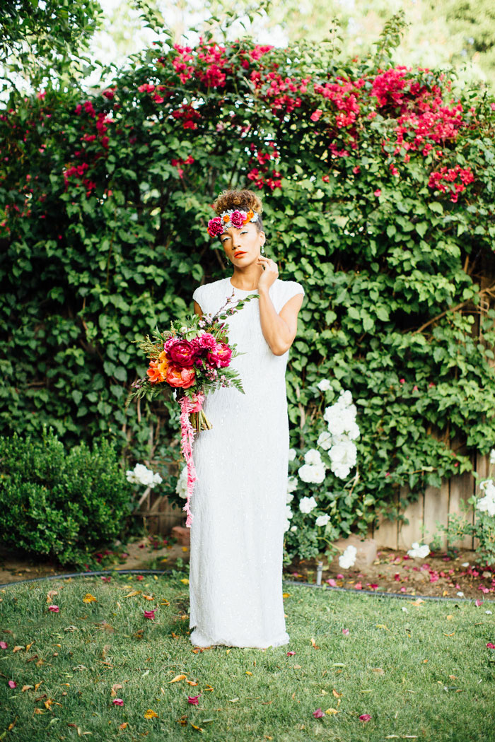 Beautiful bride with colorful floral headpiece and bouquet.