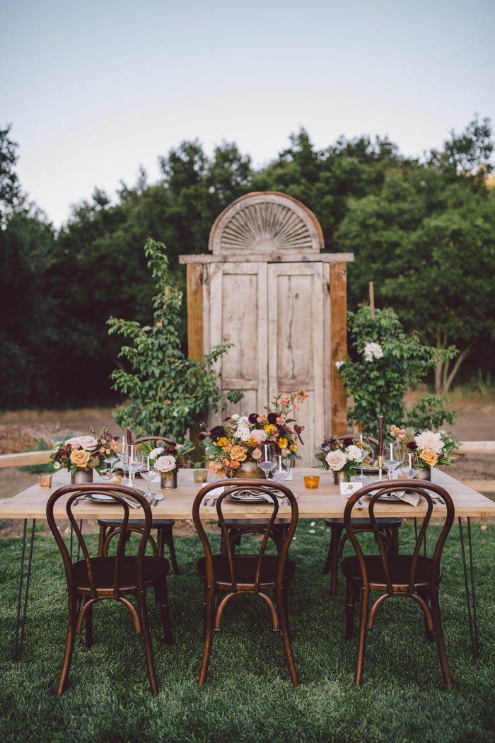 Fall tablescape set against rustic wooden doors at Stonewall Ranch, Malibu