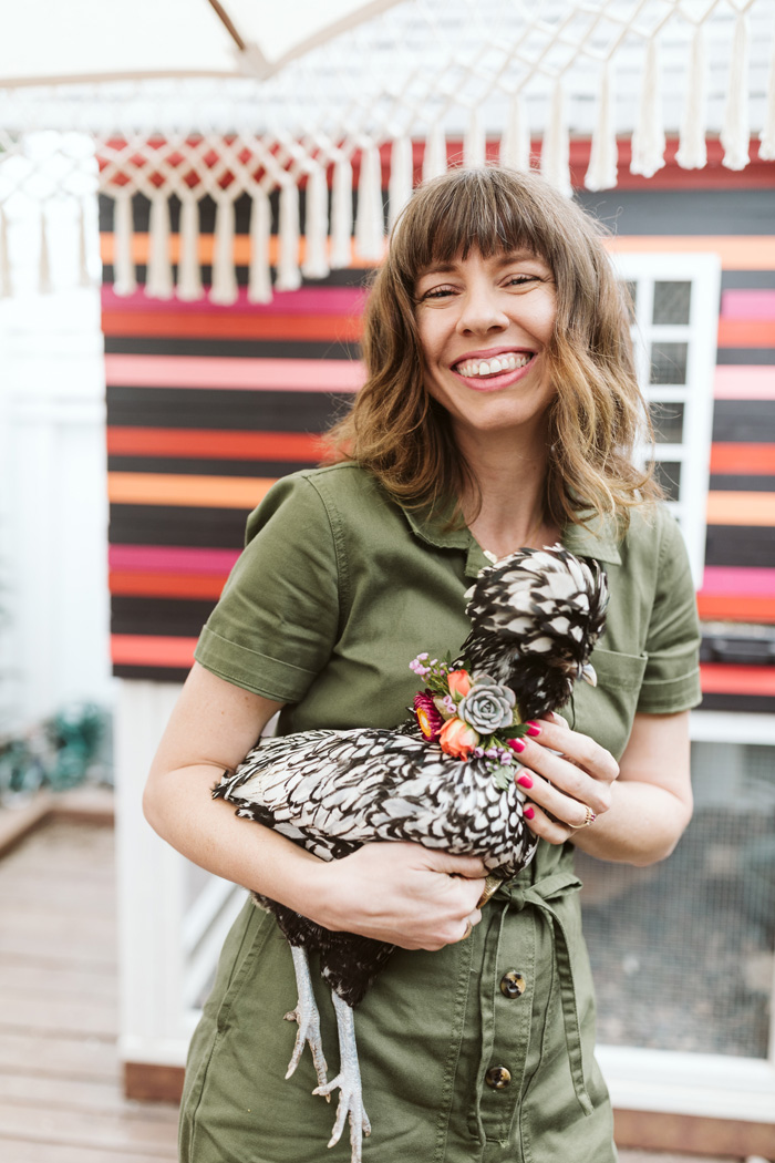 Winston and Main's Tabitha Abercrombie holding a polish chicken wearing a flower necklace