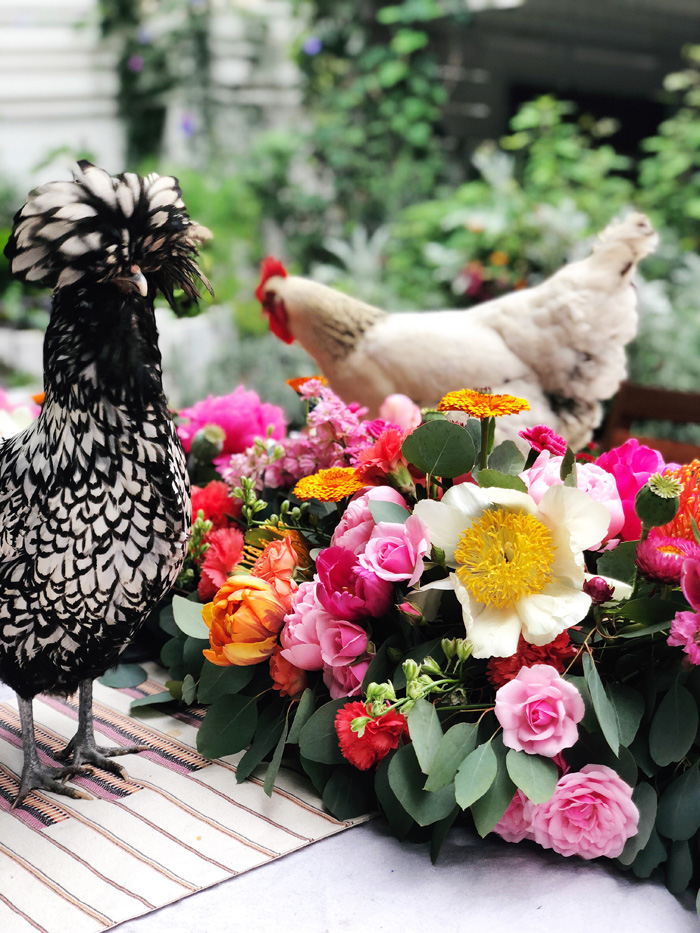 Backyard chickens frolicking in lush floral table garland