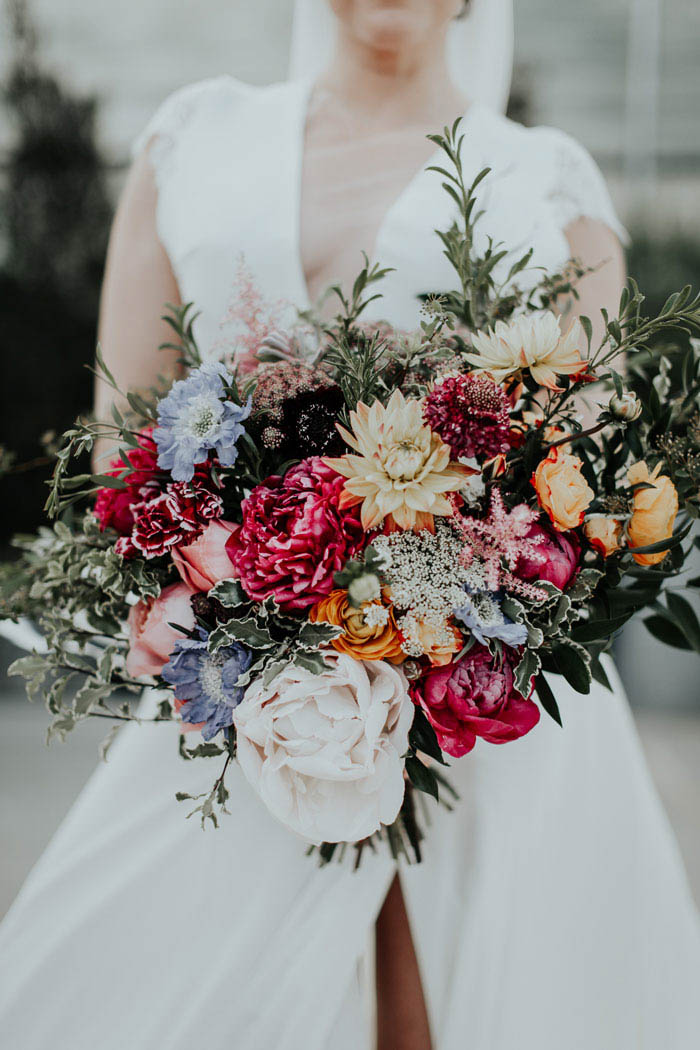 Lush bridal bouquet full of peonies, dahlias, and organic greenery.