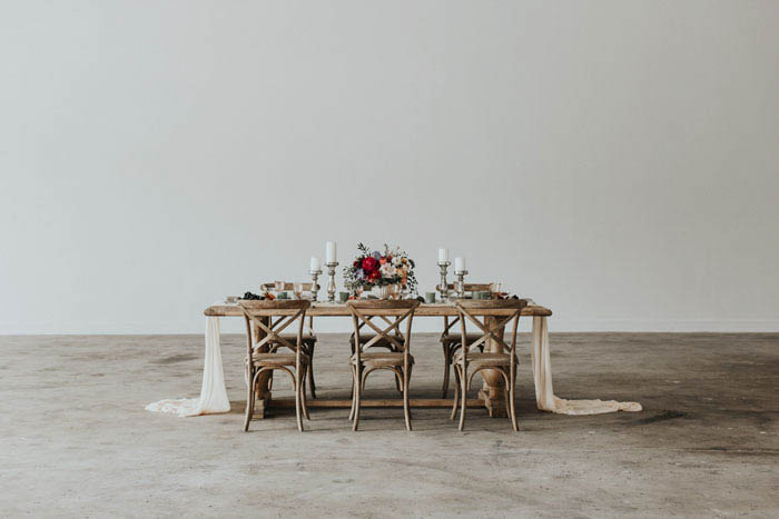 Beautiful head tablescape with lush and romantic jewel tones and lots of candlelight.