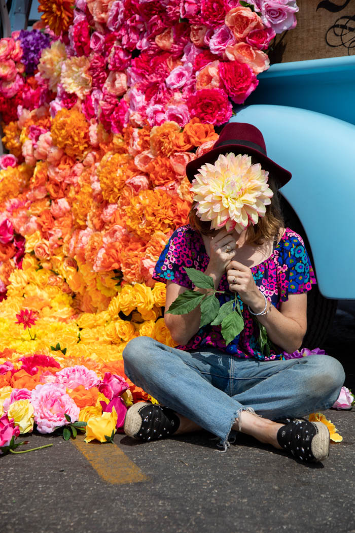 Tabitha Abercrombie of Winston & Main poses with a dinner plate dahlia and a backdrop of colorful flowers!