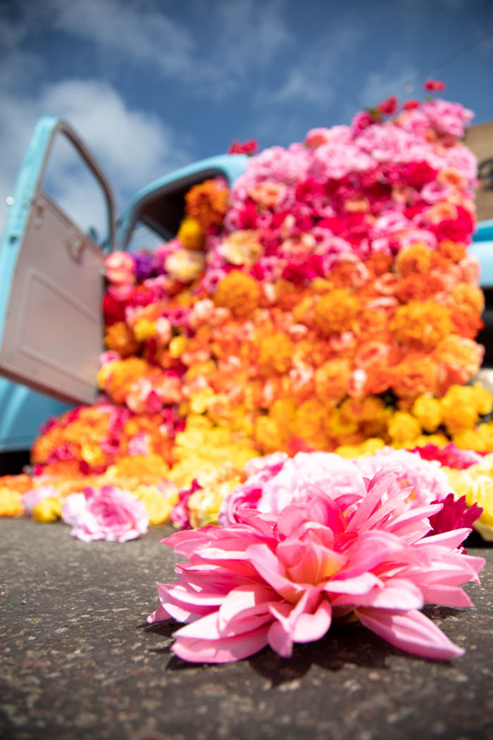 Bright floral blanket spills out of vintage blue chevy for Don Julio Tequila activation.