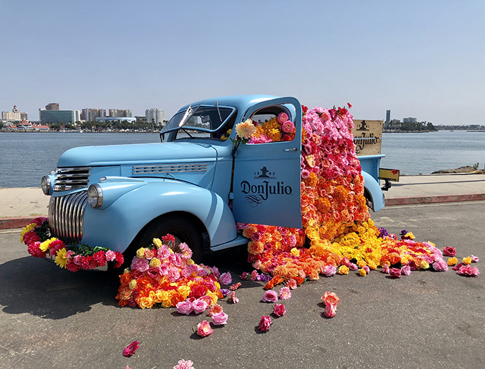 Colorful flower installation on the vintage blue Don Julio Tequila truck