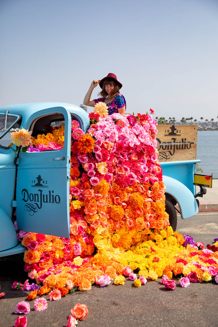 Tabitha Abercrombie of Winston & Main poses with her floral installation for Don Julio Tequila