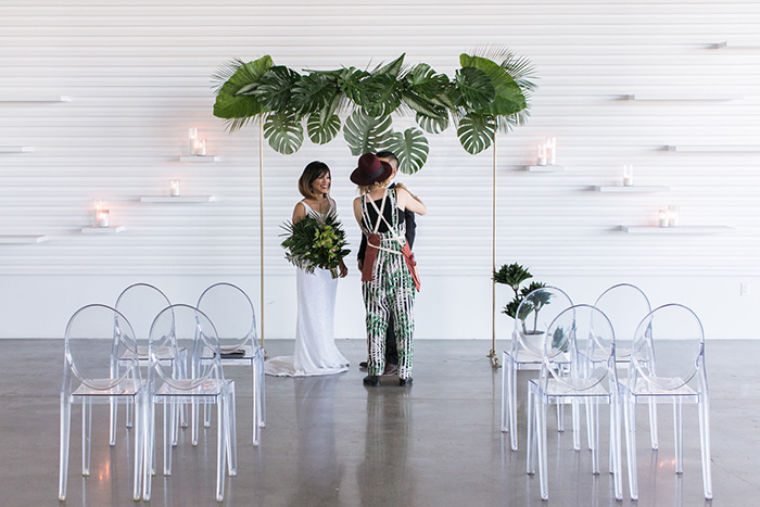 Tabitha Abercrombie of Winston & Main makes some behind the scenes adjustments to groom's boutonniere before shooting for Tropical Wedding Editorial.