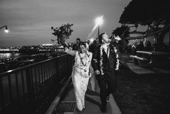 A joyful + just married couple lead a second line to their wedding reception!