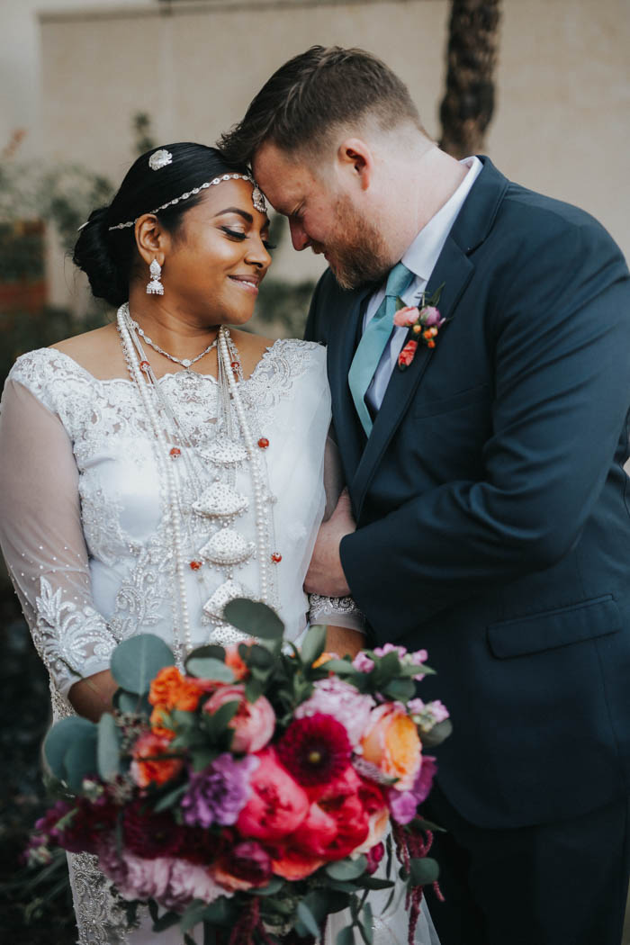 Romantic and colorful modern multicultural wedding couple share a sweet first look.