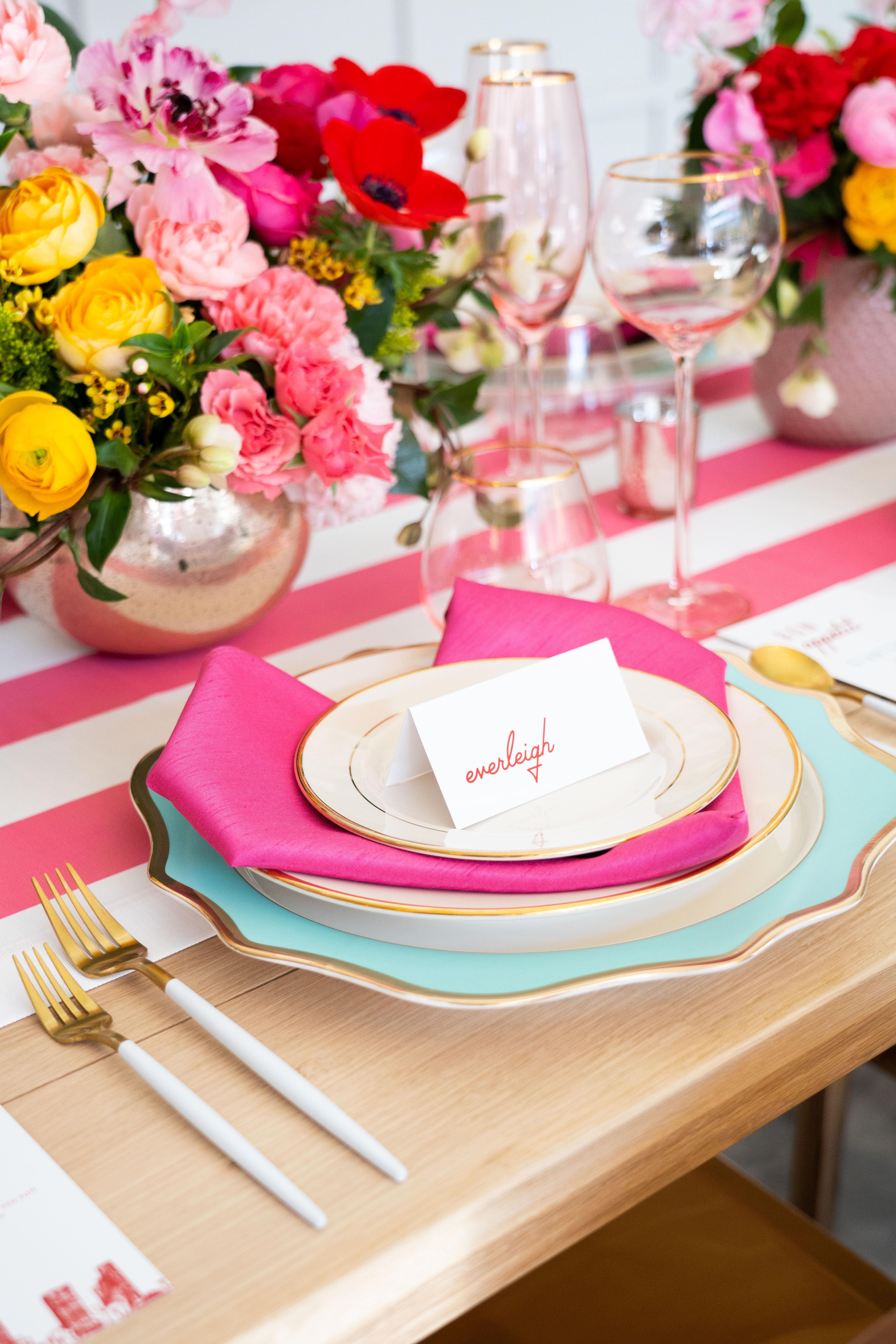 Our Valentine's Day reception featuring colorful dining ware with touches of gold and lush yellow, red, and pink flower arrangements full of peonies and anemones by Winston and Main.