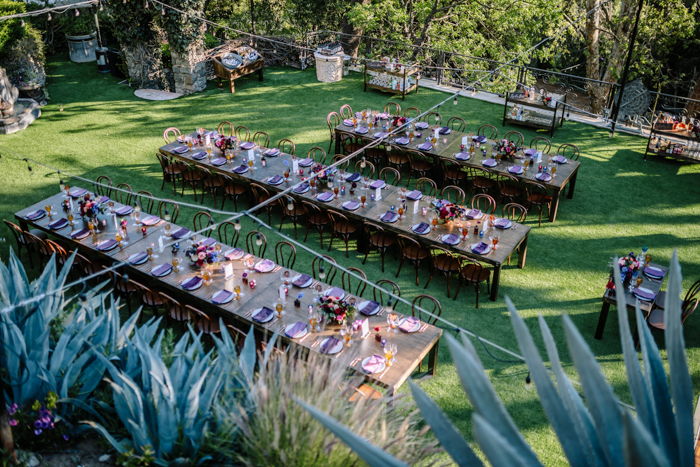 Houdini Estate's beautiful reception lawn adorned with jewel toned flowers by Winston and Main.