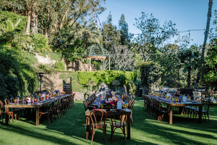 The Houdini Estate wedding reception with jewel toned flower arrangements designed by LA florist Winston and Main