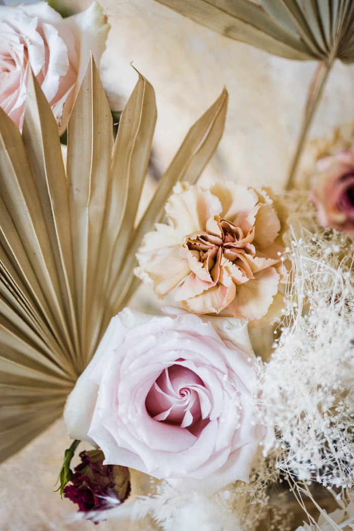 Wedding table flowers featuring sun palms and muted color flowers for natural, ethereal style inspiration