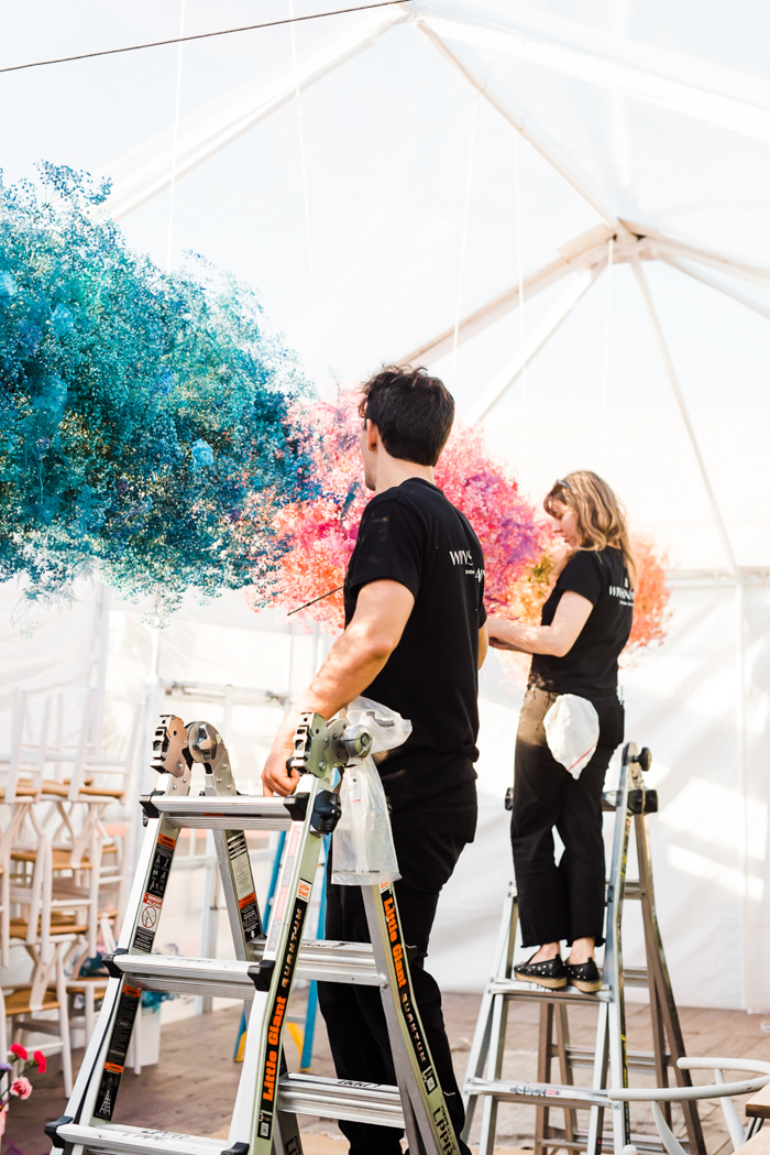 Team Winston & Main installs 21 feet of floral clouds.