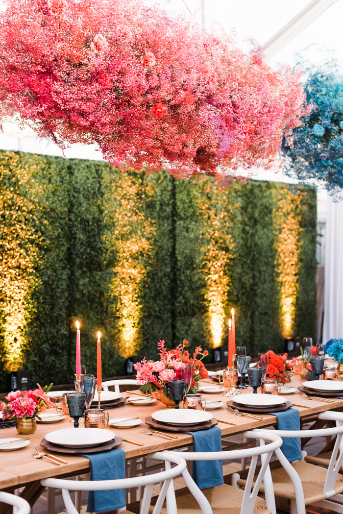 Dyed & painted babies breath clouds hanging over long tables at intimate & colorful birthday celebration.