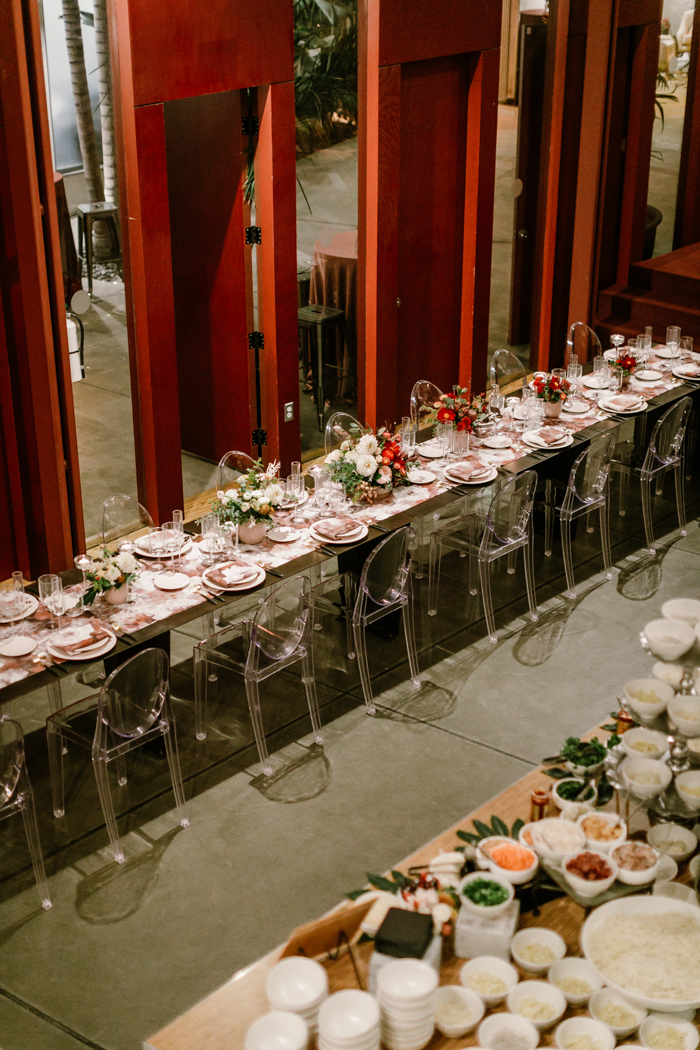 A birds-eye-view of a long ombre tablescape, and a ramen bar at Kim Sing Theatre. 