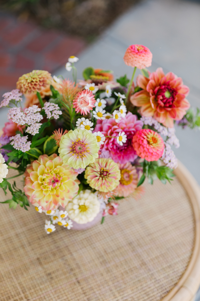 A colorful summer arrangement featuring local dahlias & zinnias in shades of yellow, peach, coral, pink and more, by Winston & Main.