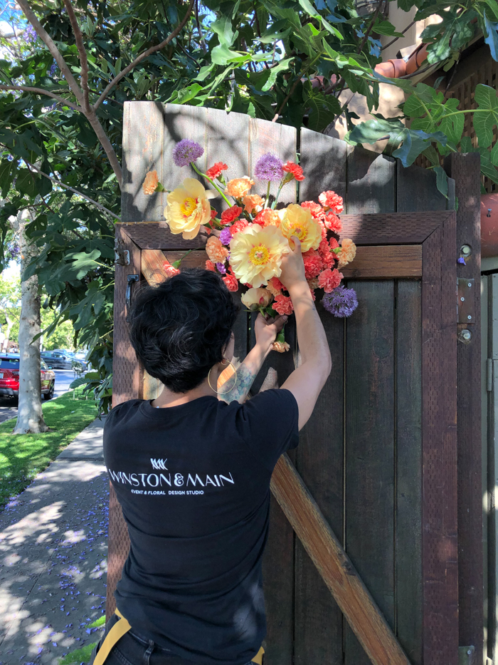 A Winston & Main team member finished a foam-free floral installation on a gate for a recent wedding.