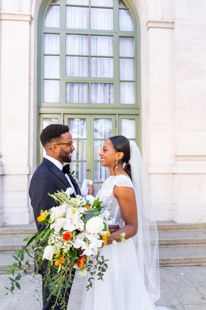 A beautiful cascade bouquet in white, green, and orange for our Leap Day Wedding at the Ebell Los Angeles, as featured on Martha Stewart.