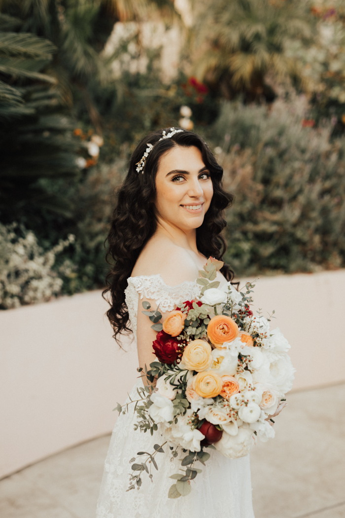 A bride and her beautiful Winston & Main bouquet, photographed by Heirlume Photography at The Bel Aire Hotel.