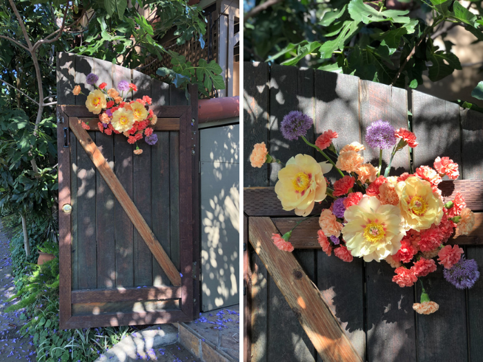 A foam-free floral installation on the venue gate serves to welcome guests with bold and colorful peonies, carnations, and whimsical purple allium.