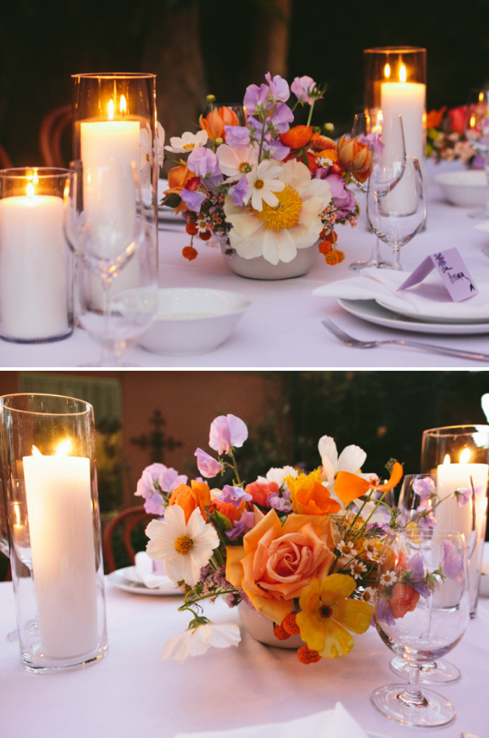 Whimsical wedding centerpieces by Winston & Main, featuring Claire De Lune Peonies, Poppies, Allium, Garden Roses, and Ranunculus paired with pillar candles makes for a romantic, candlelit tablescape.