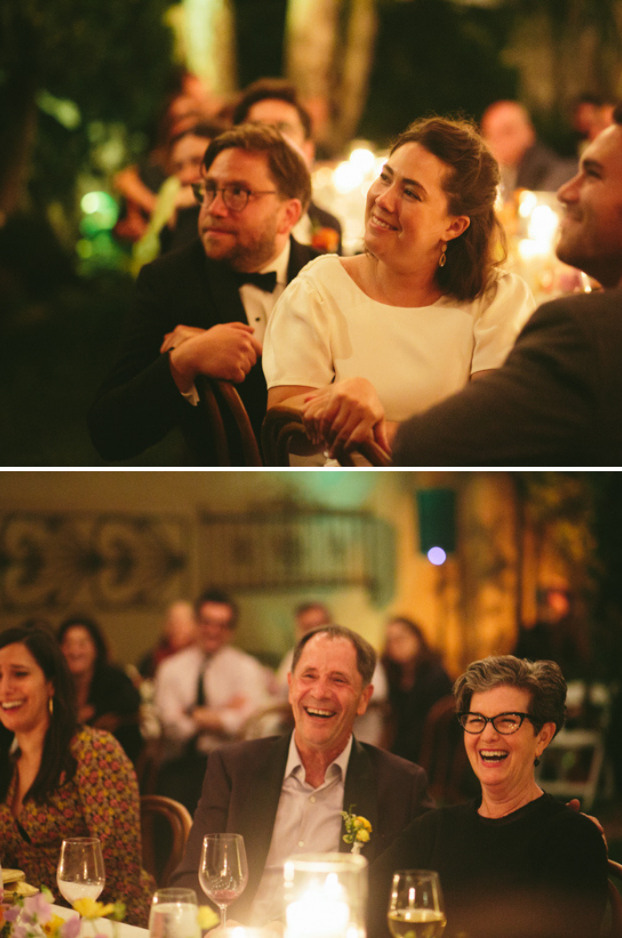 The newlyweds and parents with joyful reactions to family toasts in a beautiful backyard wedding, featuring spring florals designed by Winston & Main.