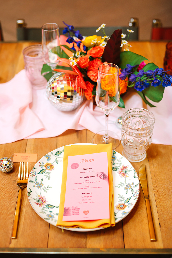 The perfect place setting featuring vintage plates, beautiful paper goods, disco balls, and our colorful florals.