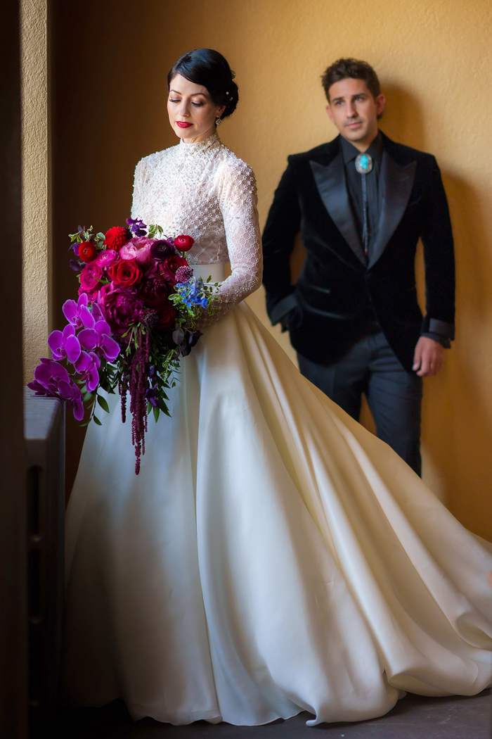 A wedding portrait of the couple at the historic Ebell of Los Angeles, featuring a modern cascade bouquet full of bold phalaenopsis orchids. 